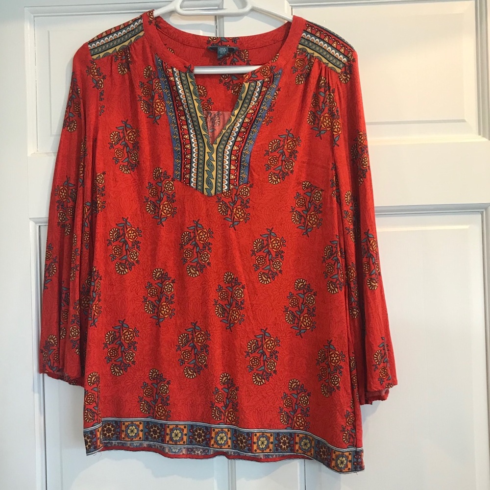 Orange blouse with flowers and other designs